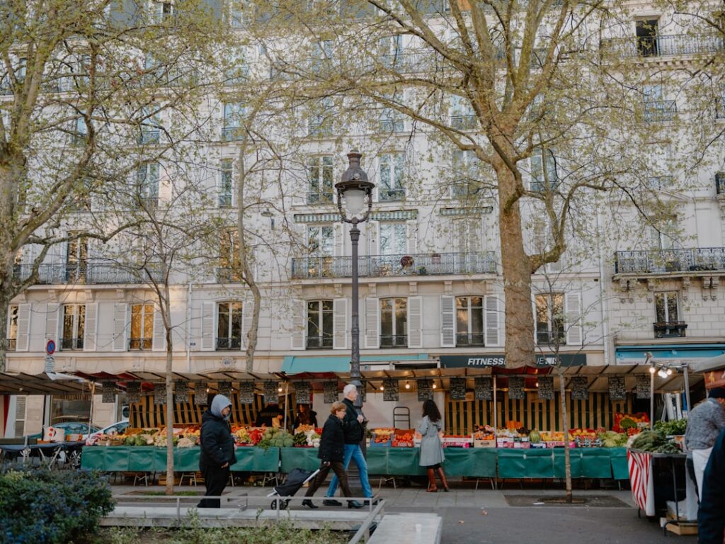 People browsing stalls at an outdoor market in paris